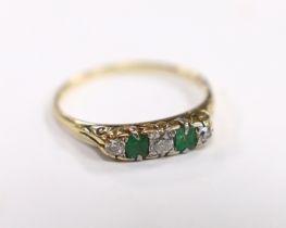 An 18ct, two stone emerald and three stone diamond set half hoop ring, size U, gross weight 2.8