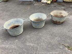 Three circular galvanised two handled containers, one marked N G Ltd., and dated 1955, diameter