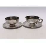 Two early 20th century Vietnamese 800 standard white metal tea cups and saucers (one lacking