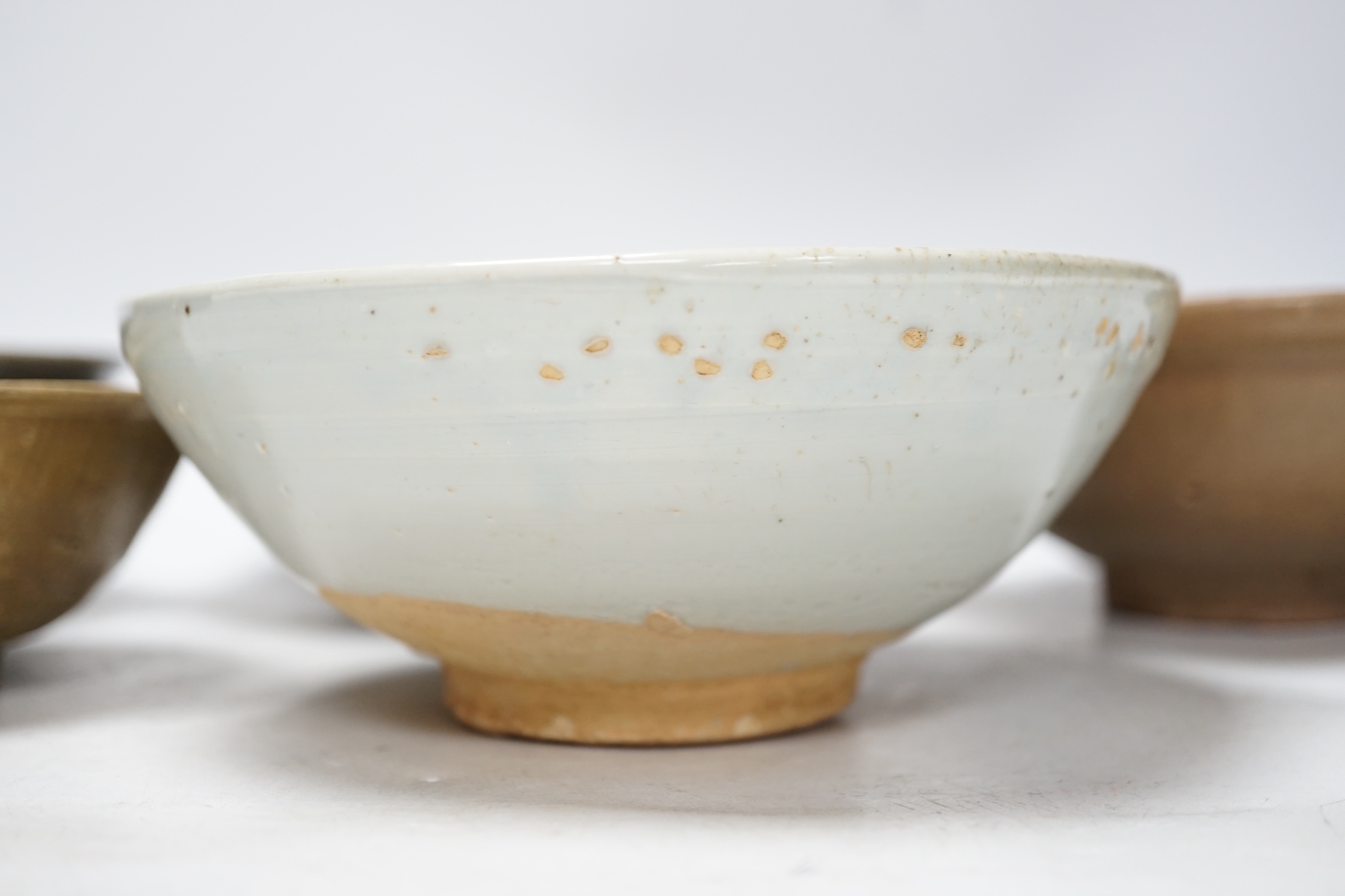 A group of four Chinese Longquan or Yue ware celadon bowls and a Qingbai bowl, Song-Yuan dynasty, - Image 4 of 10
