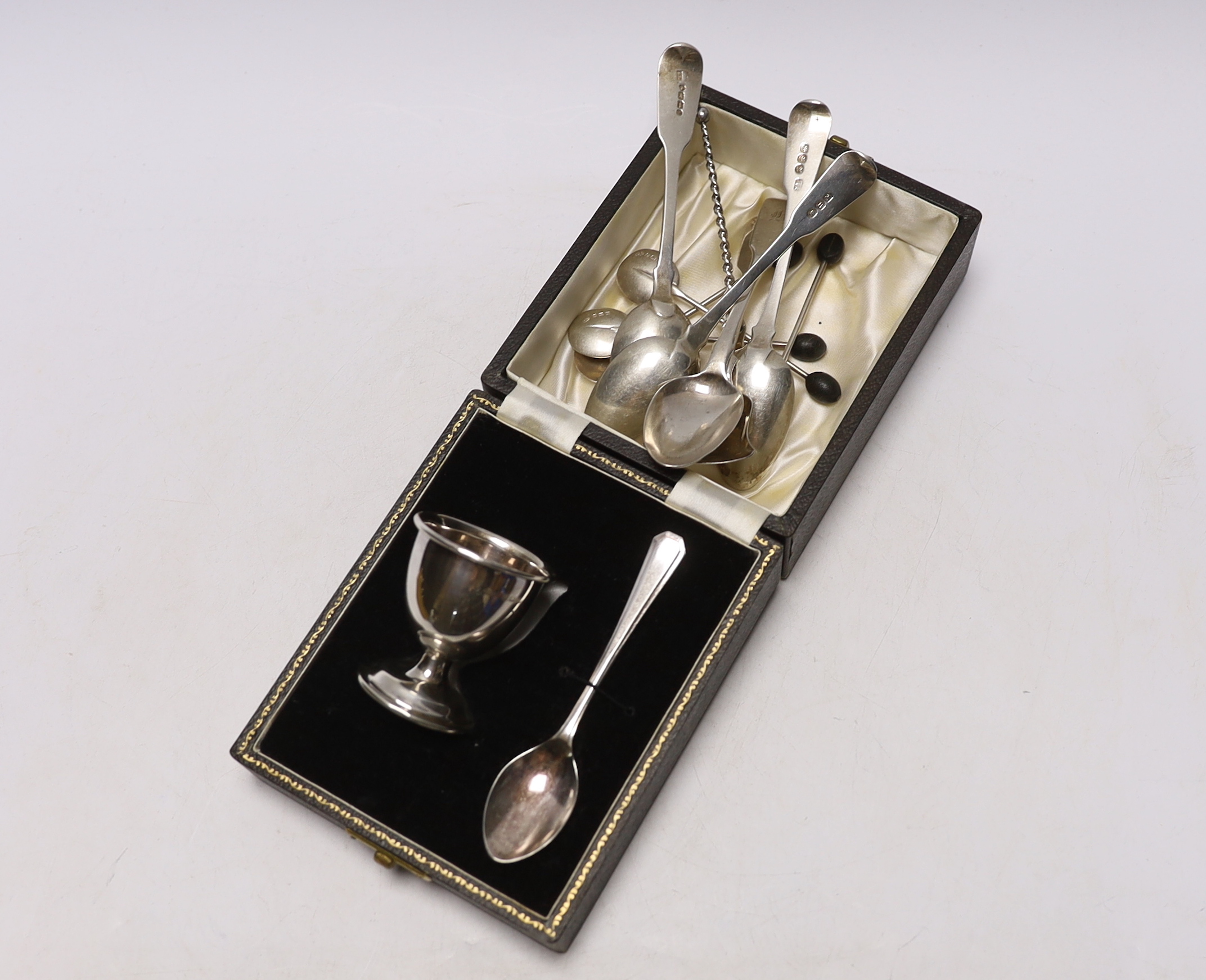 A cased silver egg cup, spoon and other assorted silver flatware.