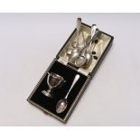 A cased silver egg cup, spoon and other assorted silver flatware.