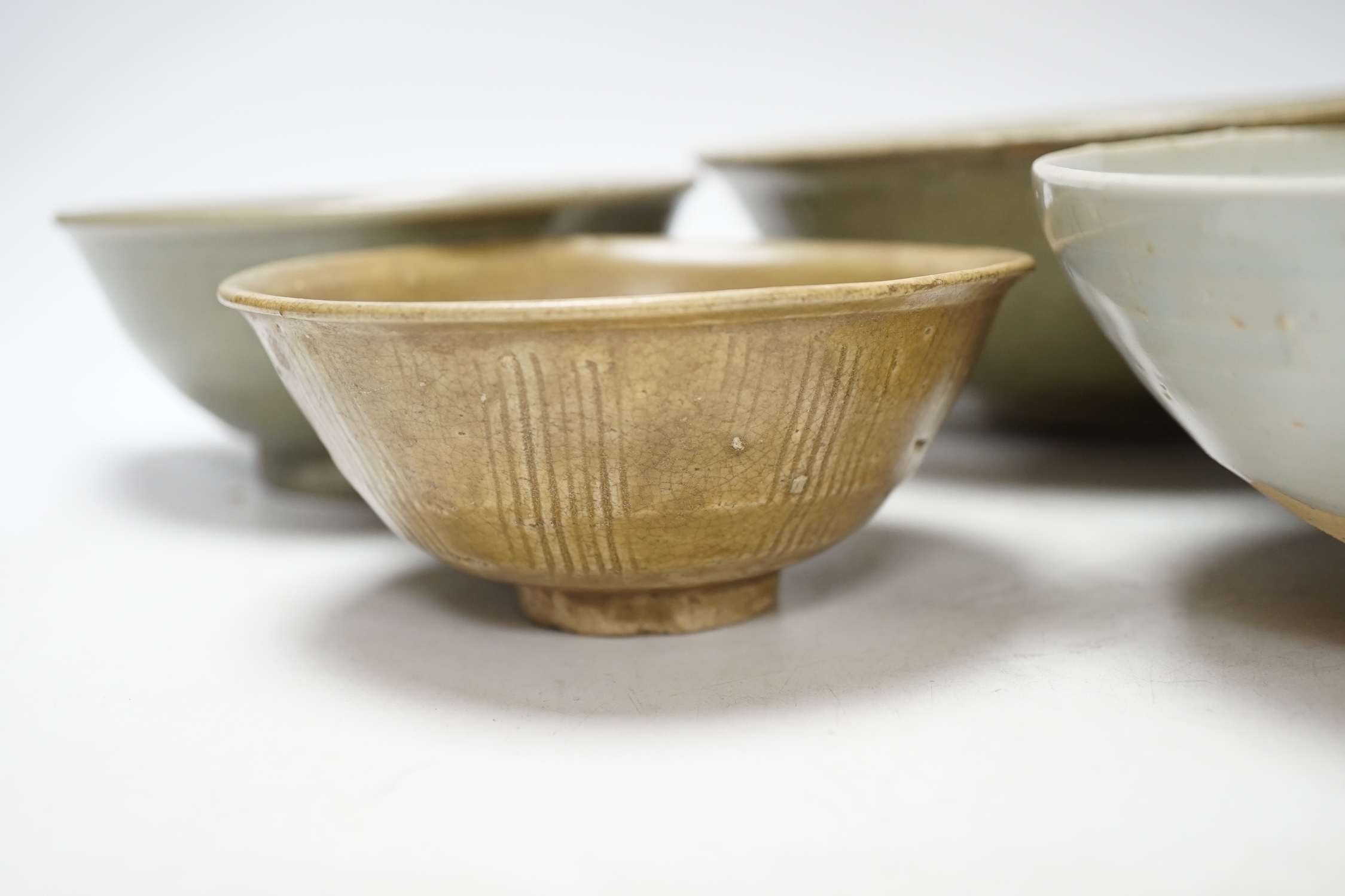 A group of four Chinese Longquan or Yue ware celadon bowls and a Qingbai bowl, Song-Yuan dynasty, - Image 3 of 10