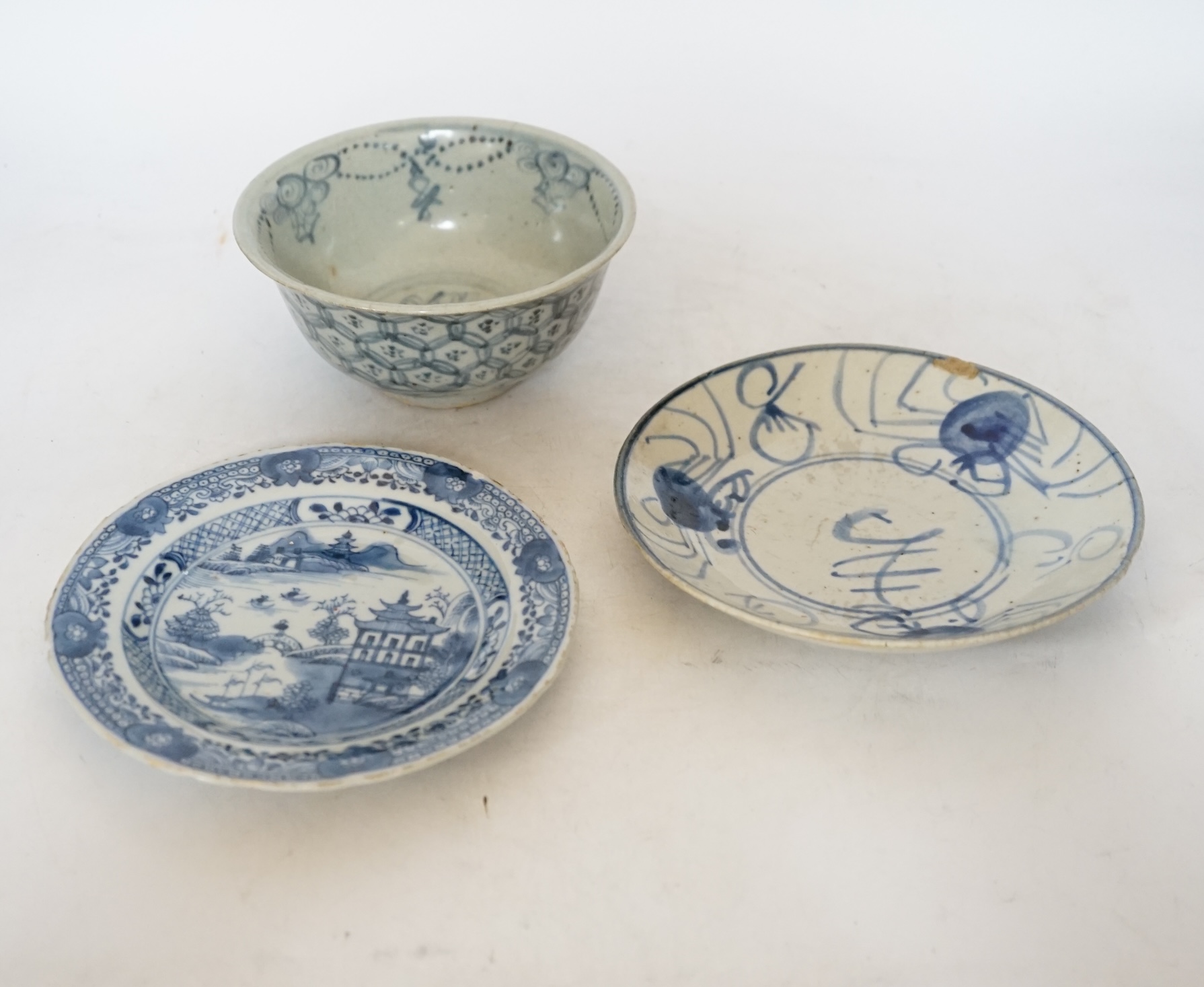A Chinese Ming blue and white bowl and two Qing dynasty dishes, largest 17cm diameter