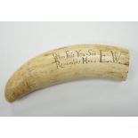 A 19th century Scrimshaw walrus tooth with carved motto ‘When this you see, remember mee’ and