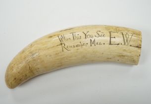 A 19th century Scrimshaw walrus tooth with carved motto ‘When this you see, remember mee’ and