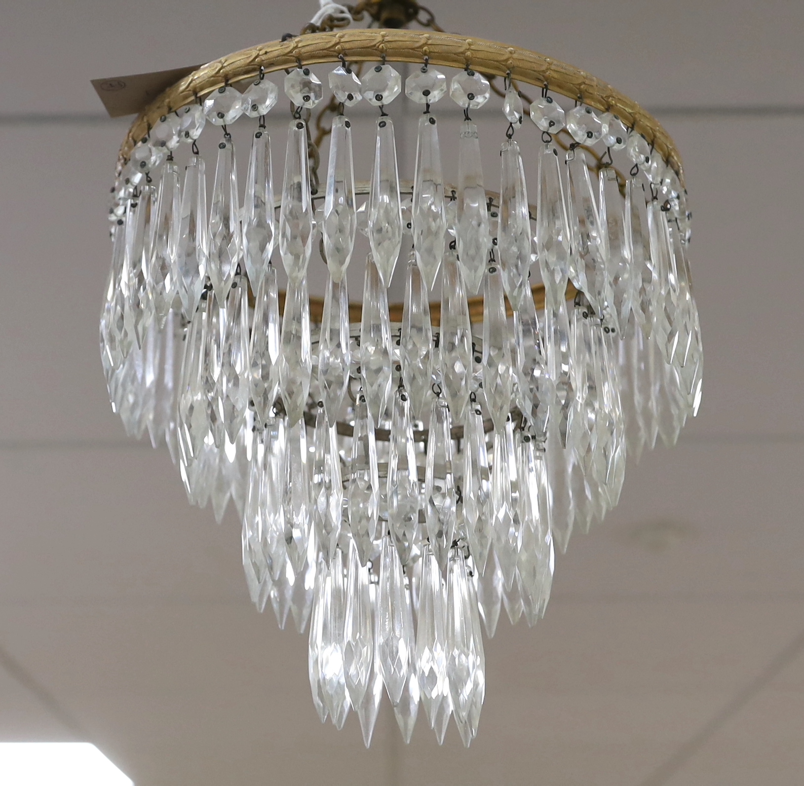 A pair of cut glass four tier chandeliers, 35cm long