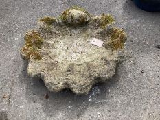 A reconstituted stone scallop shell bird bath, (missing column) width 55cm