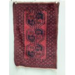 Two Afghan red ground rugs, larger 170 x 120cm