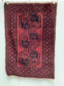 Two Afghan red ground rugs, larger 170 x 120cm