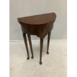 A small reproduction George III style circular topped mahogany D shaped folding table, diameter