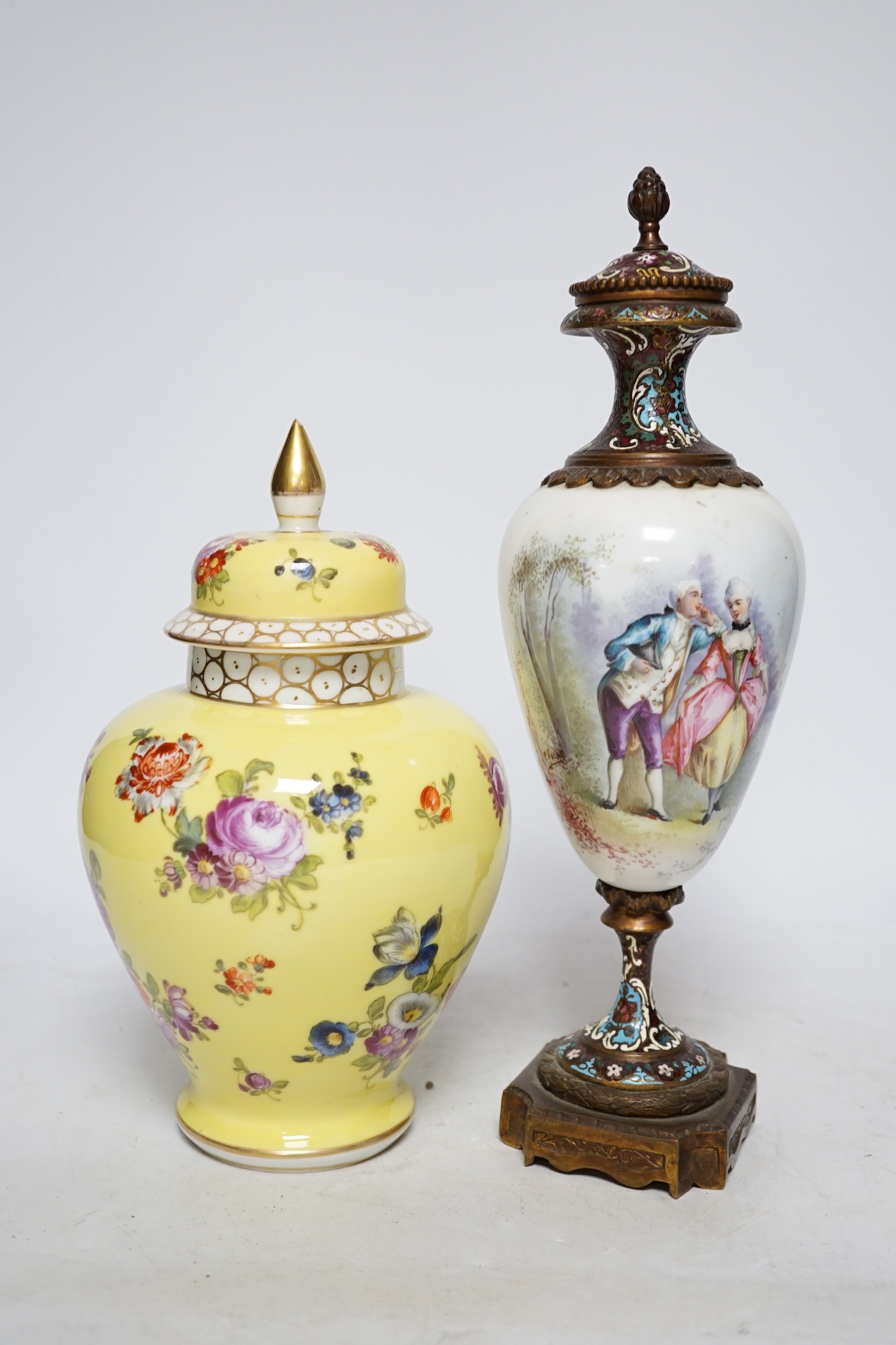 A 19th century French ormolu, enamel and porcelain urn and cover and a Dresden yellow urn and cover,