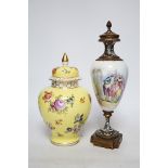 A 19th century French ormolu, enamel and porcelain urn and cover and a Dresden yellow urn and cover,