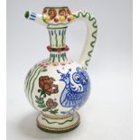 A Zsolnay jug or ewer decorated with peacocks and flowers, stamped ‘Zsolnay 830 and 07’ to the base,