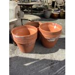 Six large circular terracotta planters, largest diameter 49cm, height 40cm