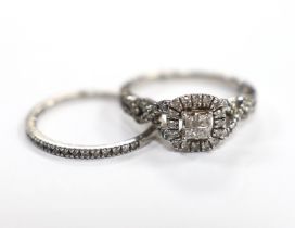 A modern white metal and diamond set cluster ring, with diamond set shoulders size N and a similar