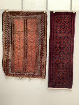 A Belouch red ground rug and a runner, larger 155 x 106cm