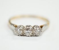 An 18ct, plat and three stone diamond set ring, size P/Q, size 2.6 grams.