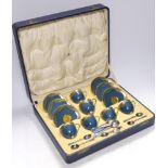 A cased Royal Worcester gilt and powder blue six piece coffee set with silver teaspoons, set of