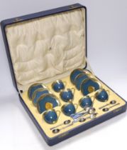 A cased Royal Worcester gilt and powder blue six piece coffee set with silver teaspoons, set of