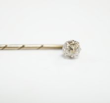An early 20th century cased yellow metal and cushion cut solitaire diamond set stick pin, 57mm,