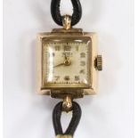 A lady's 9ct gold Trebex manual wind wrist watch, on a twin fabric strap.