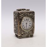 A late Victorian repousse silver cased carriage timepiece, by William Comyns, London, 1899, with