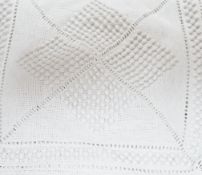 An early 20th century French knitted and crocheted bedcover with bobble motifs, 220cm x 200cm