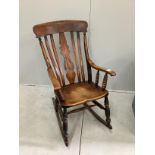 A Victorian elm and beech Windsor lathe back rocking chair, width 57cm, height 106cm