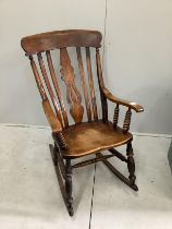 A Victorian elm and beech Windsor lathe back rocking chair, width 57cm, height 106cm