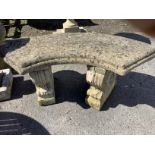 A reconstituted stone curved garden seat, width 106cm, depth 46cm, height 44cm