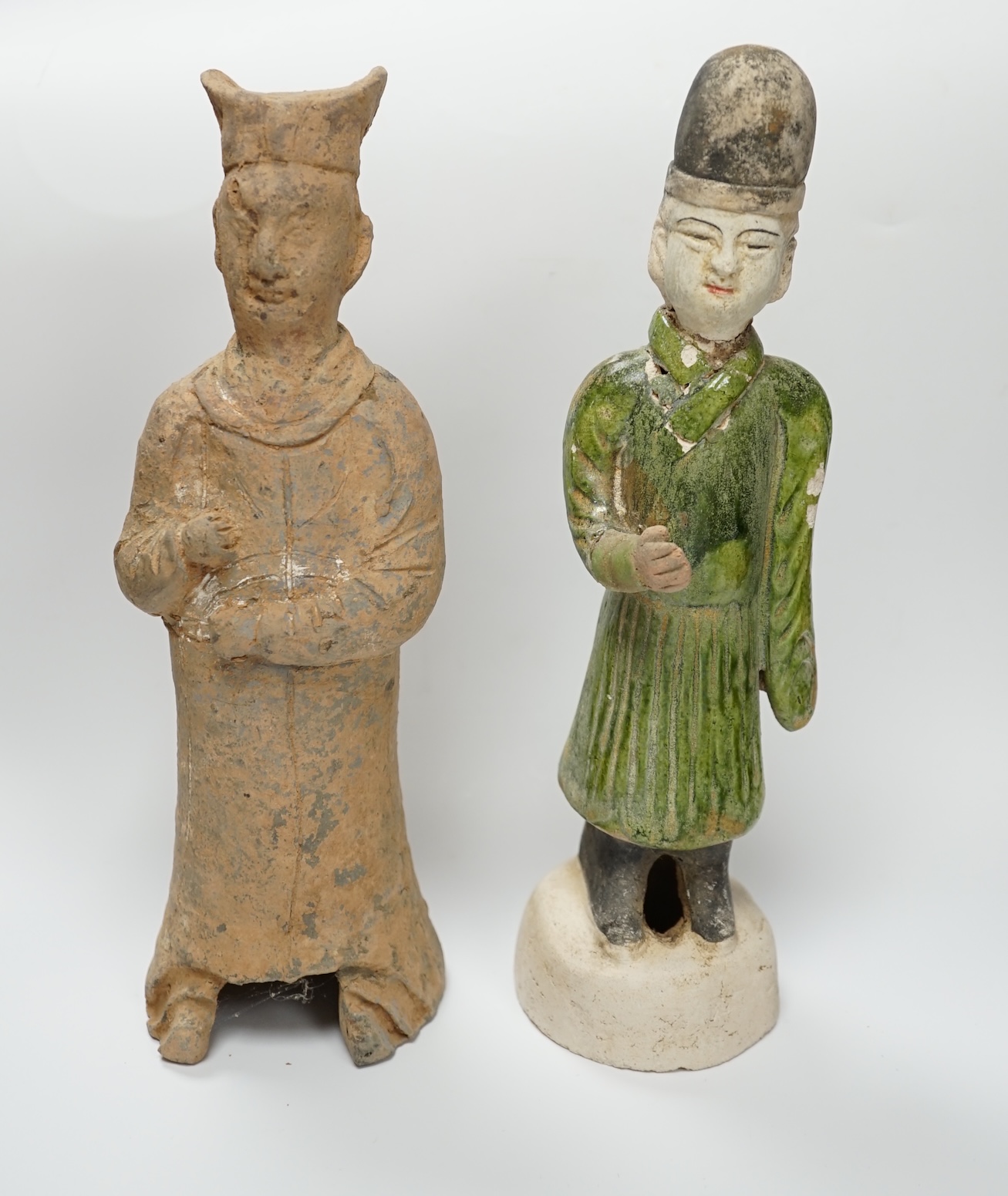 A Chinese grey pottery figure, Han dynasty, and a green glazed figure, Ming dynasty, 23cm