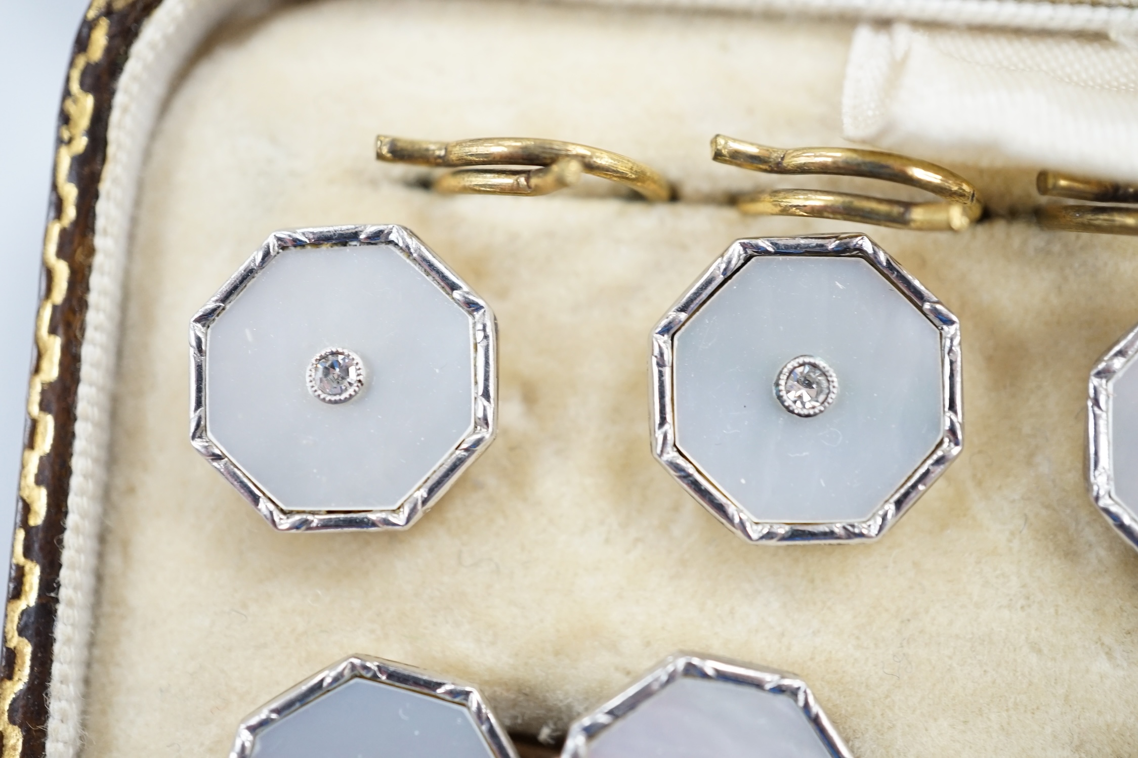 A cased eight piece 9ct, mother of pearl and diamond chip set dress stud set. - Image 2 of 3