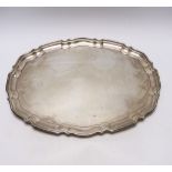 A George V silver shaped oval tray, by Viners Ltd, Sheffield, 1938?, on four ball feet, 46.5cm, 52.