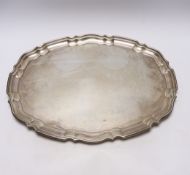 A George V silver shaped oval tray, by Viners Ltd, Sheffield, 1938?, on four ball feet, 46.5cm, 52.