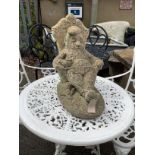 A reconstituted stone seated gnome garden ornament, length 40cm