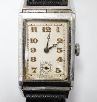 A gentleman's mid 20th century steel 'reverso' manual wind rectangular dial wrist watch, with Arabic