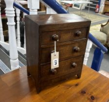 An early 19th century mahogany three drawer miniature chest, width 25cm, depth 14cm, height 32cm