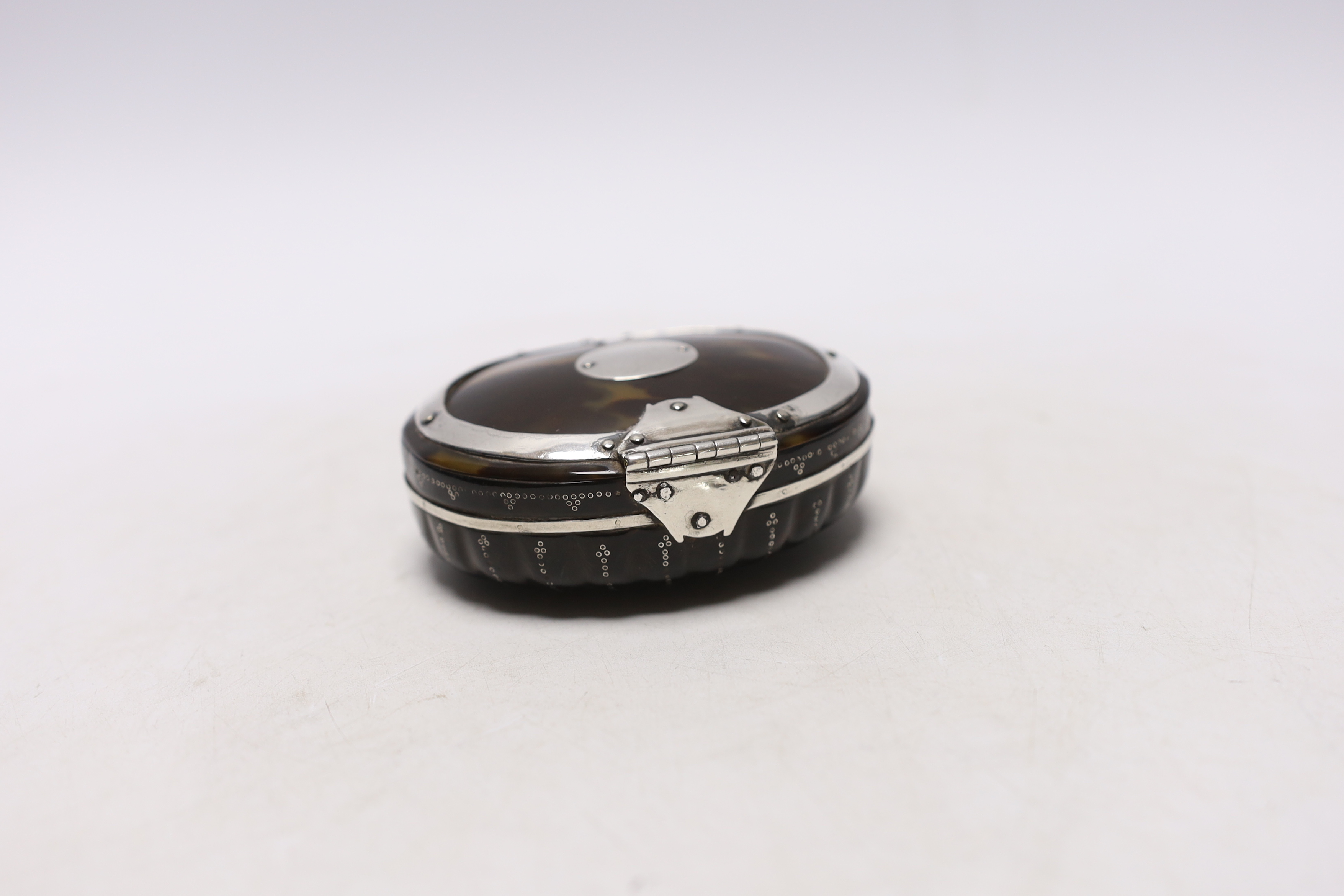 An early 19th century unmarked white metal mounted oval tortoiseshell snuff box, with fluted base, - Image 2 of 3