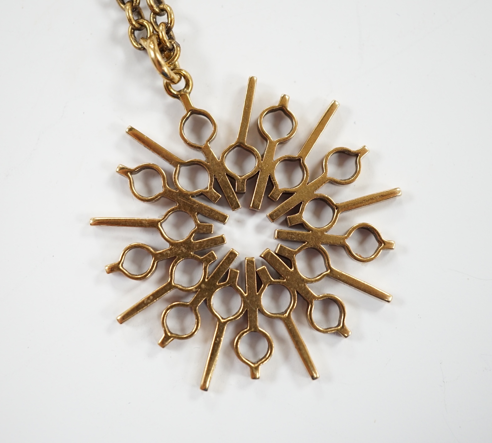A yellow metal pendant, 37mm, on a 375 chain, 52cm, gross weight 17.8 grams.