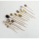 Fifteen assorted mainly early 20th century yellow metal and gem set stick pins, including diamond,