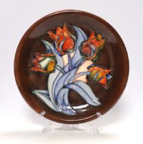 A Moorcroft 'Red Tulip' dish designed by Sally Tuffin, 26cm in diameter