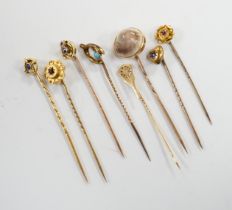 Eight assorted early 20th century and later yellow metal and gem set stick pins, including six 15ct,