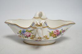 An 18th century Sevres sauceboat, probably later enamelled with flowers, 23.5cm wide