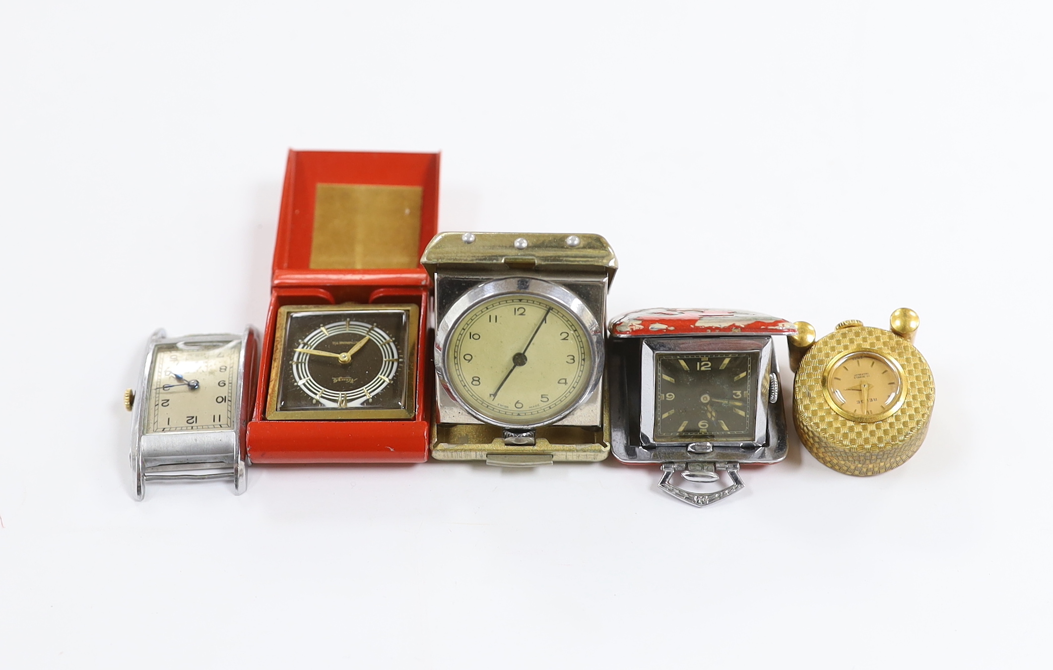 Four miniature travelling timepieces and a wrist watch