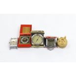 Four miniature travelling timepieces and a wrist watch