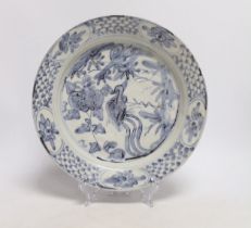 A Chinese Swatow blue and white 'phoenix' plate, late Ming, 25cm diameter
