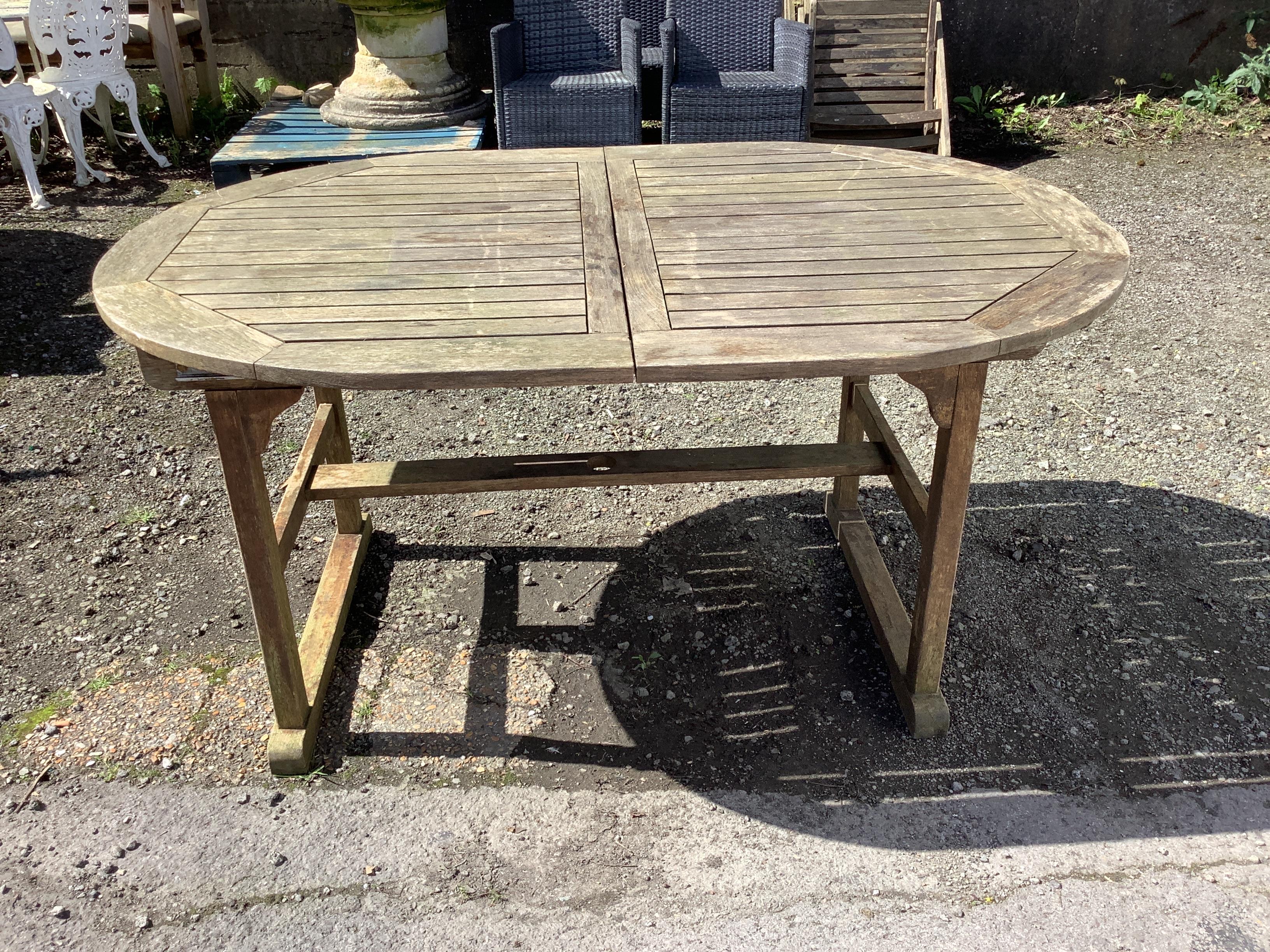 A weathered teak extending garden table, width 150cm, depth 100cm, height 74cm, together with six - Image 2 of 3
