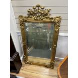 An early 20th century carved giltwood and composition wall mirror, width 78cm, height 140cm