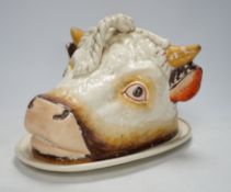 A Victorian ‘cows head’ pottery cheese dish and cover, 18cm